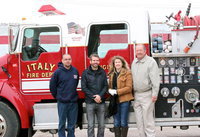 Image: Italy Fire Department lieutenant Brad Chambers, Veteran Navy Seal and parade grand marshall, Ryan “Birdman” Parrott,  city employee Rhonda Cockerham and City of Italy Mayor James Hobbs pose next to an Italy Fire Truck after Parrott received the key to the city from the Mayor.